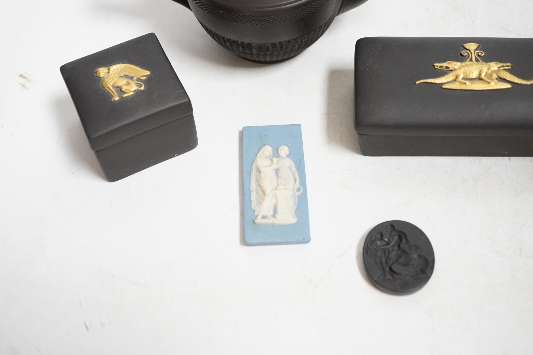 Wedgwood pieces comprising two plaques including a jasperware example and two small boxes, together with a black basalt teapot, largest 14cm wide. Condition - poor to fair